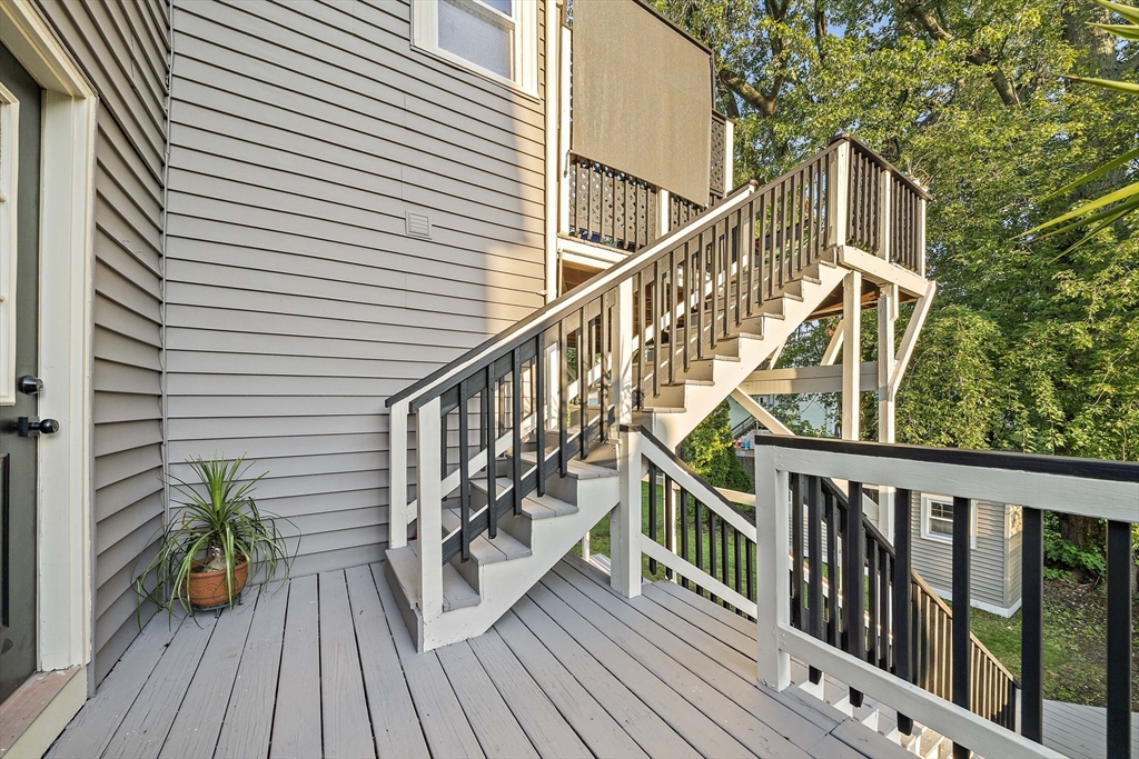 77 Botolph Street Quincy, MA 02171 - Photo 36 of 42 a view of balcony with wooden floor and fence and a potted plant