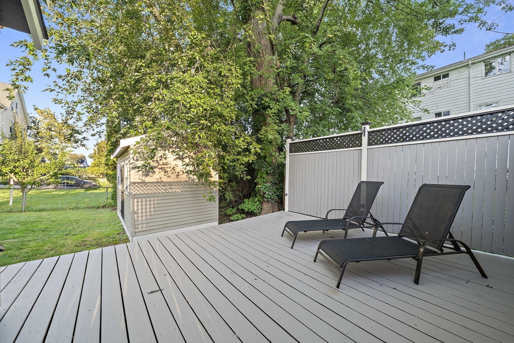 77 Botolph Street Quincy, MA 02171 - Photo 40 of 42 a view of a backyard with wooden floor and bench