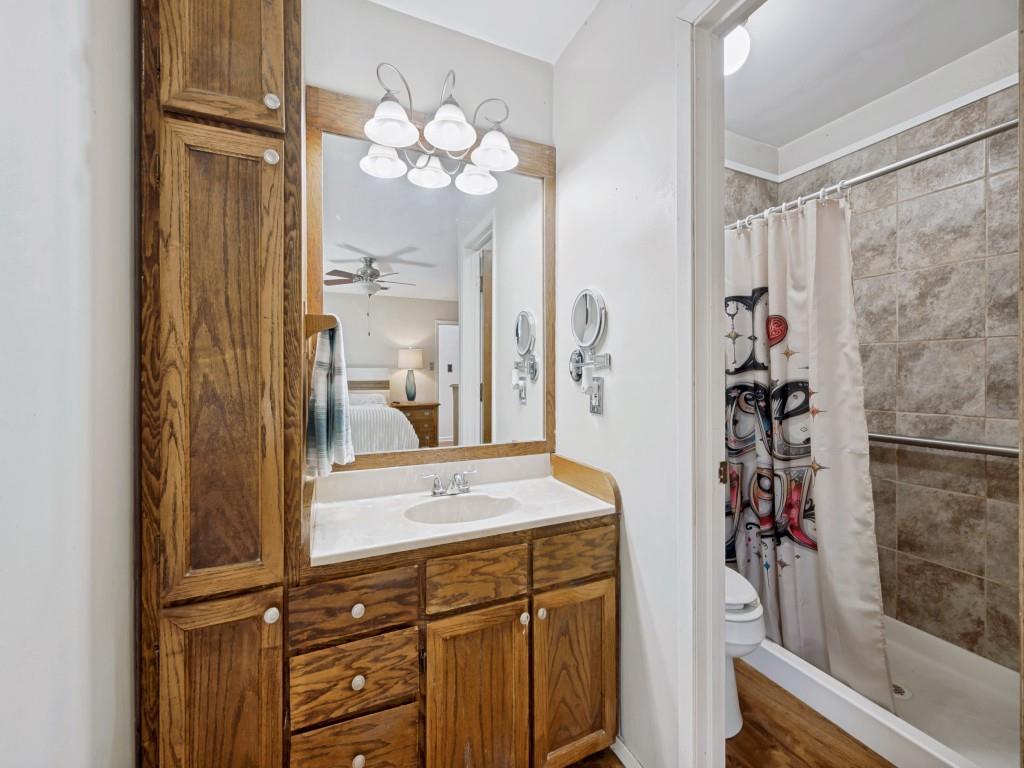 6484 Old Mill Circle Watauga, TX 76148 - Photo 15 of 25 Primary Bathroom featuring connected bathroom, vanity, a shower stall, and dark wood-type flooring