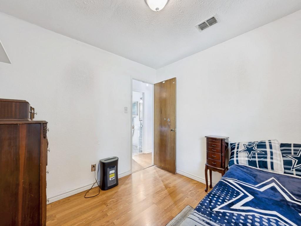 6484 Old Mill Circle Watauga, TX 76148 - Photo 17 of 25 Secondary Bedroom with light wood-style flooring and a textured ceiling