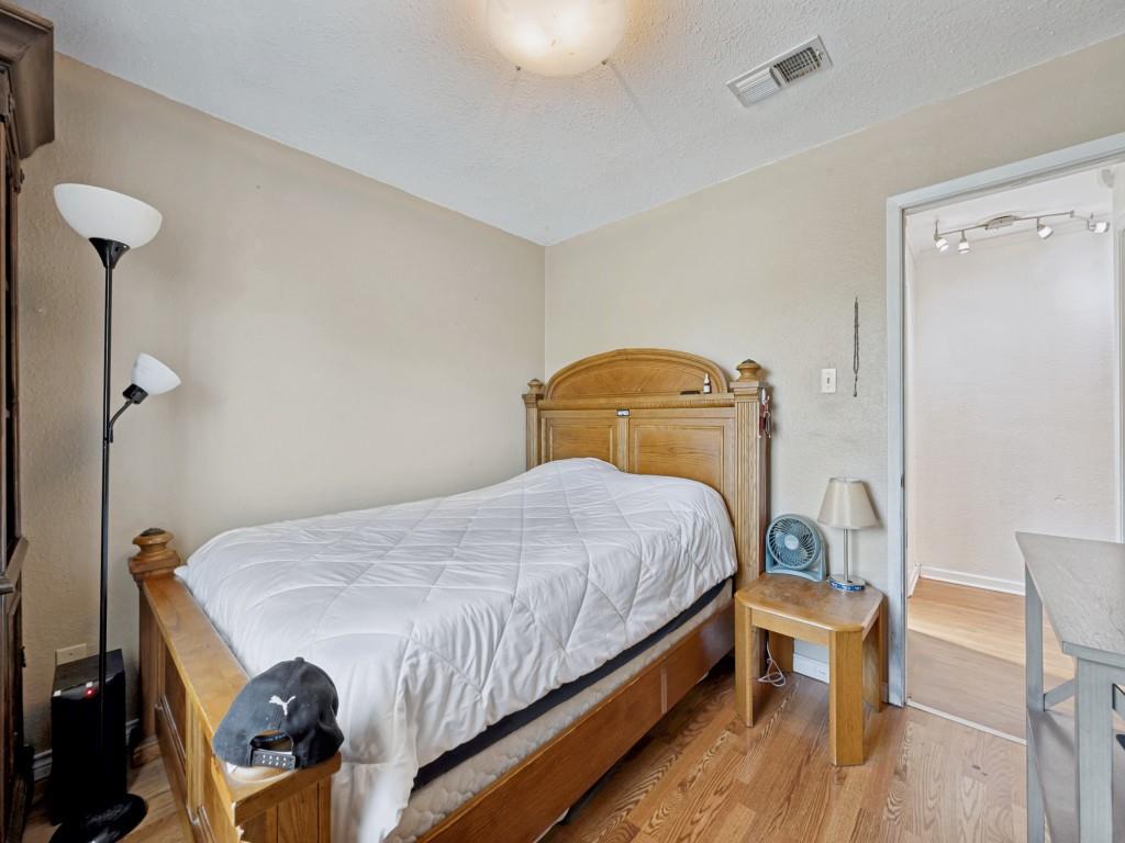 6484 Old Mill Circle Watauga, TX 76148 - Photo 20 of 25 Secondary Bedroom featuring light wood-style flooring and a textured ceiling