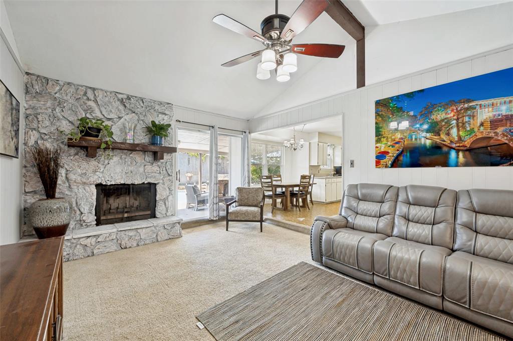 6484 Old Mill Circle Watauga, TX 76148 - Photo 5 of 25 Carpeted living area with a ceiling fan, a fireplace, hanging lights, and lofted ceiling