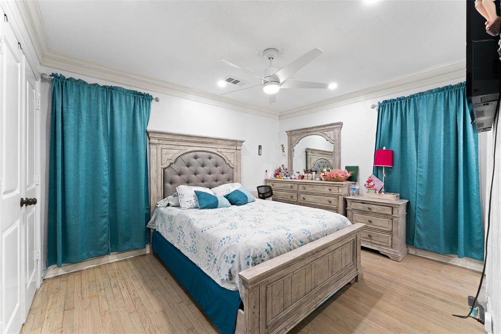 3318 San Marcus Avenue Dallas, TX 75228 - Photo 11 of 18 Bedroom with crown molding, light wood finished floors, and ceiling fan