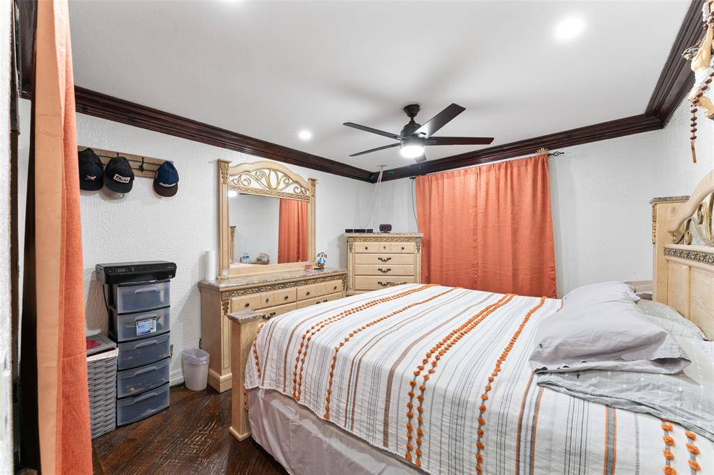 3318 San Marcus Avenue Dallas, TX 75228 - Photo 14 of 18 Bedroom featuring dark wood-style floors, crown molding, ceiling fan, a textured wall, and recessed lighting