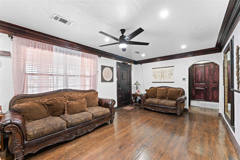 3318 San Marcus Avenue Dallas, TX 75228 - Photo 6 of 18 Living room with dark wood finished floors, crown molding, arched walkways, ceiling fan, and recessed lighting