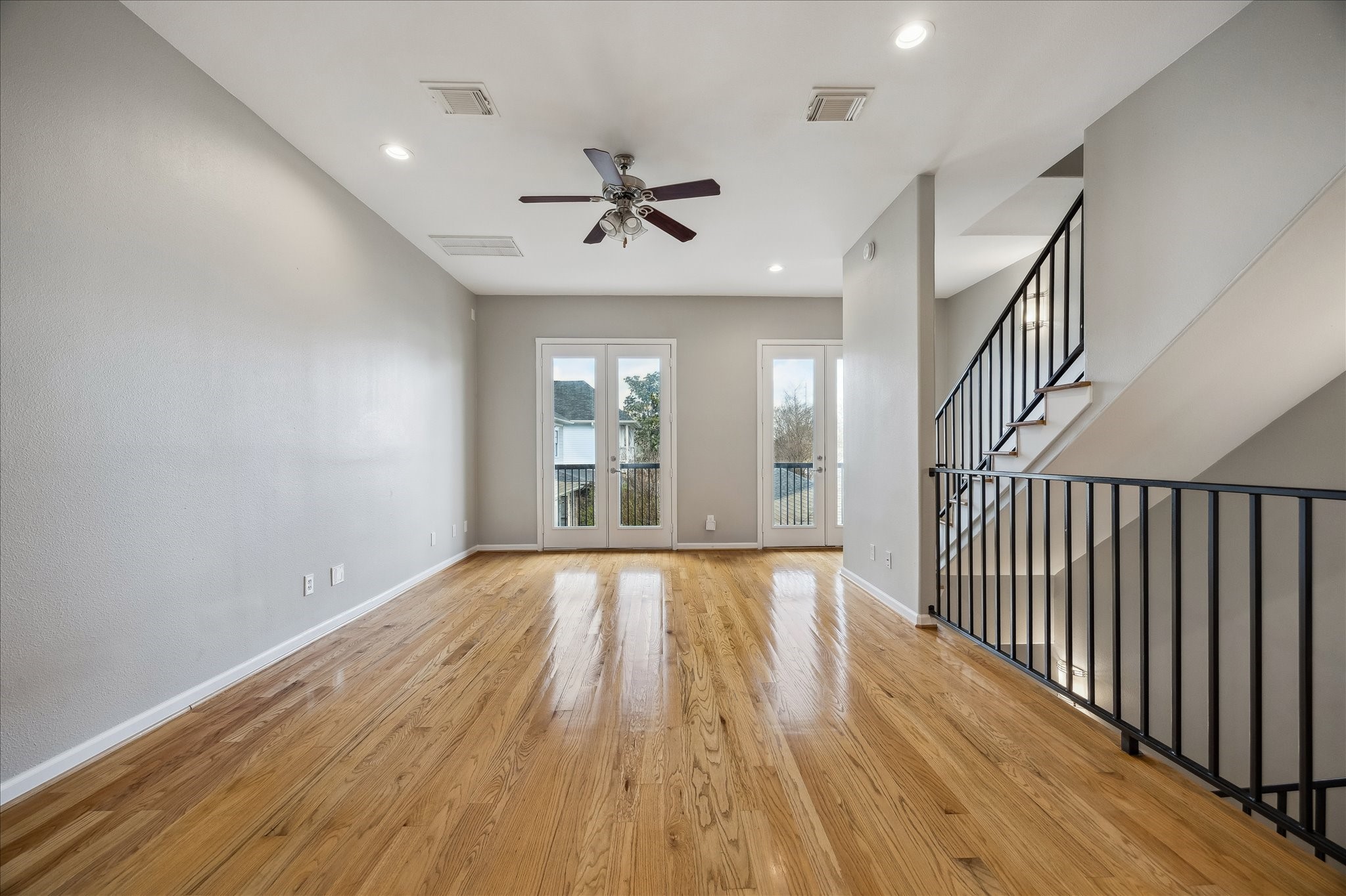 802 Waverly Street, Unit D Houston, TX 77007 - Photo 2 of 30 wooden floor in an empty room with a window