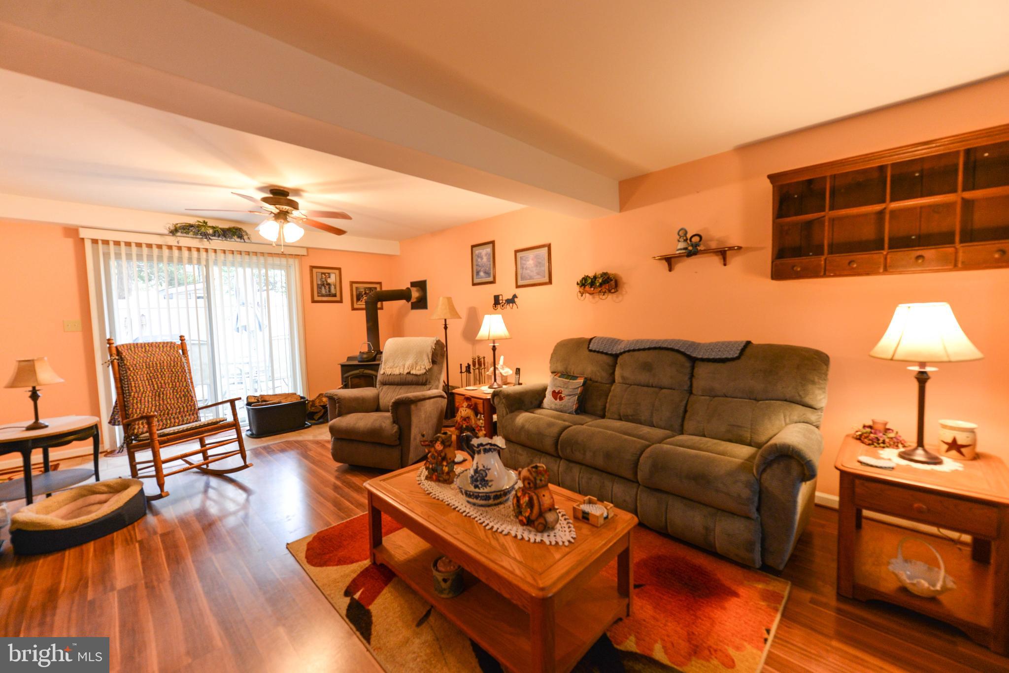 116 Tufts Road Pennsville, NJ 08070 - Photo 23 of 28 Family room with slider onto patio, woodstove
