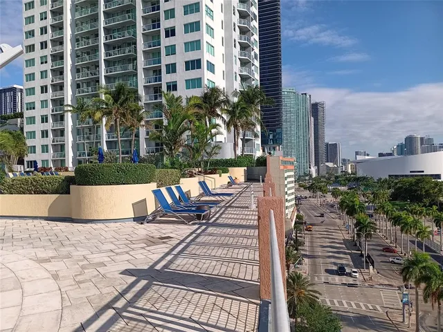 a view of a swimming pool with outdoor seating and plants