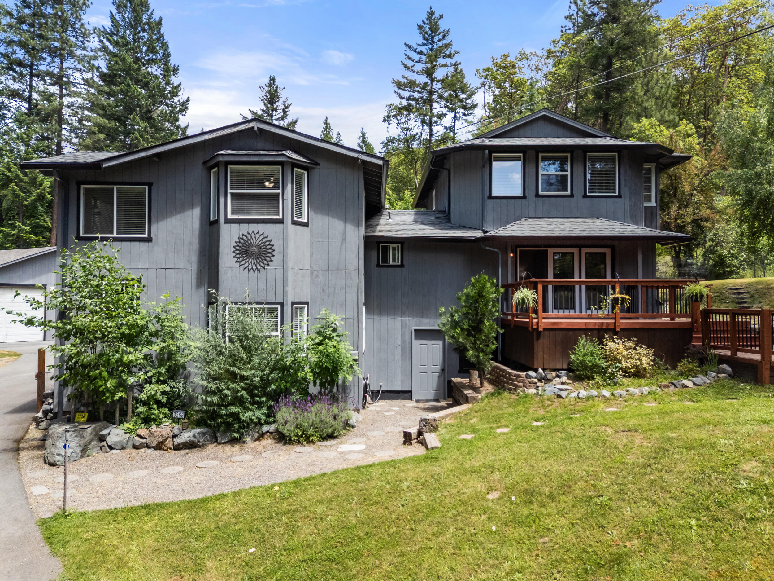 3268 Humbug Creek Road Jacksonville, OR 97530 - Photo 2 of 36 a view of a house with a yard potted plants and a table
