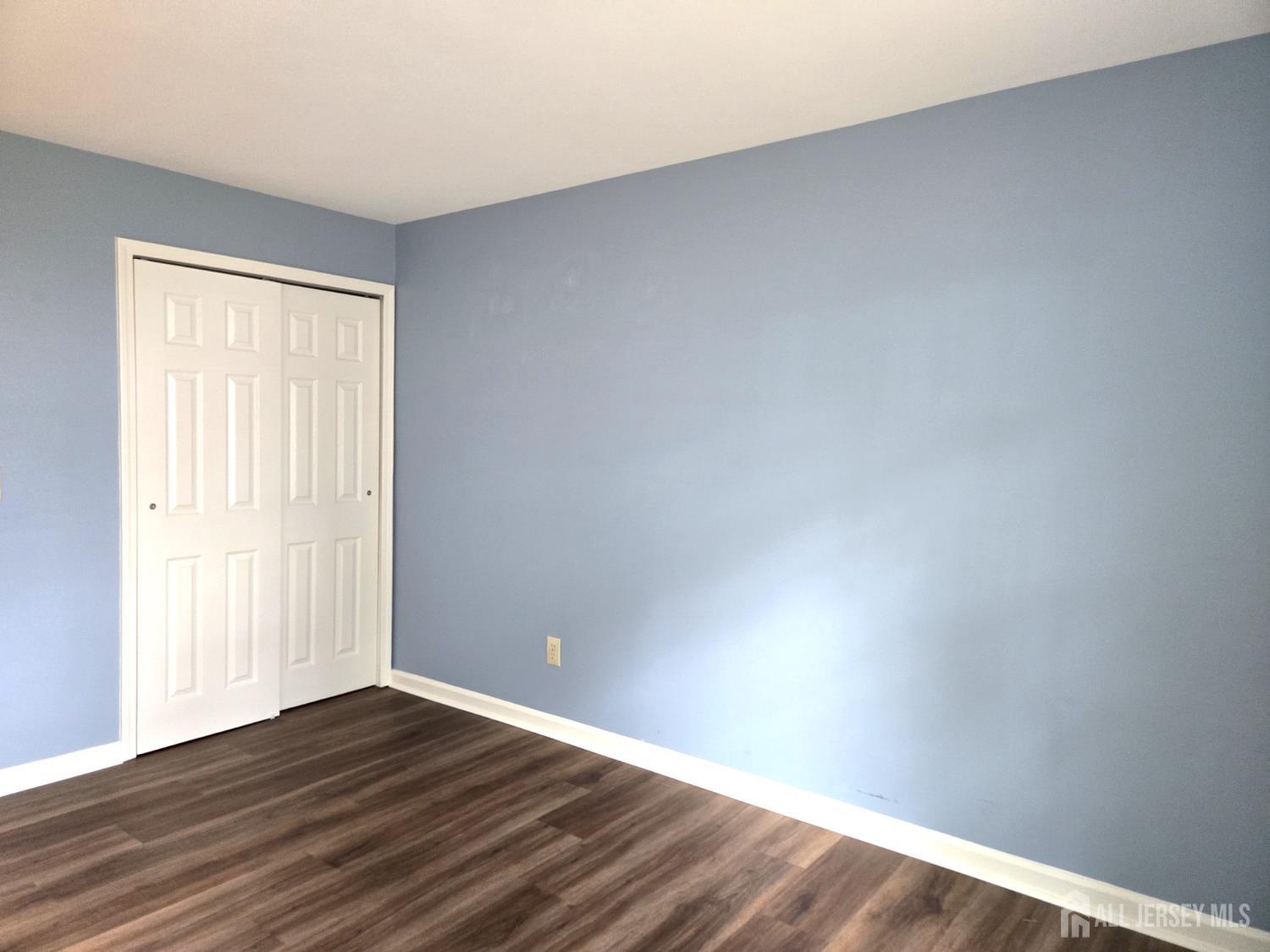 49 Alexandria Way Bernards, NJ 07920 - Photo 12 of 14 a view of an empty room with wooden floor and a window