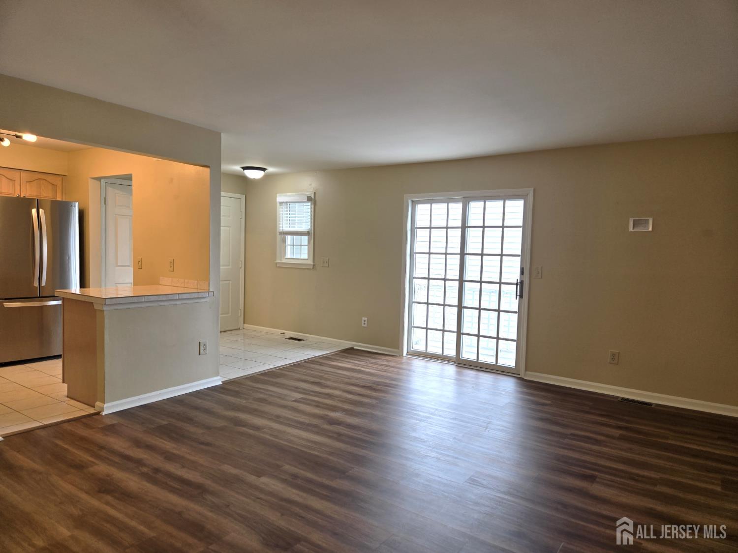 49 Alexandria Way Bernards, NJ 07920 - Photo 2 of 14 an empty room with wooden floor and windows