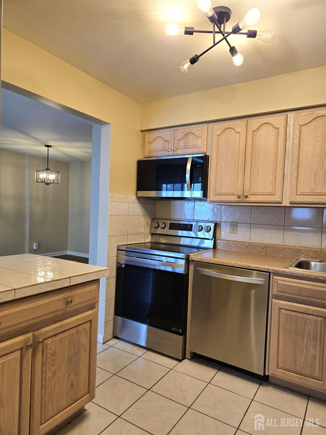 49 Alexandria Way Bernards, NJ 07920 - Photo 5 of 14 a kitchen with stainless steel appliances granite countertop a stove and a sink