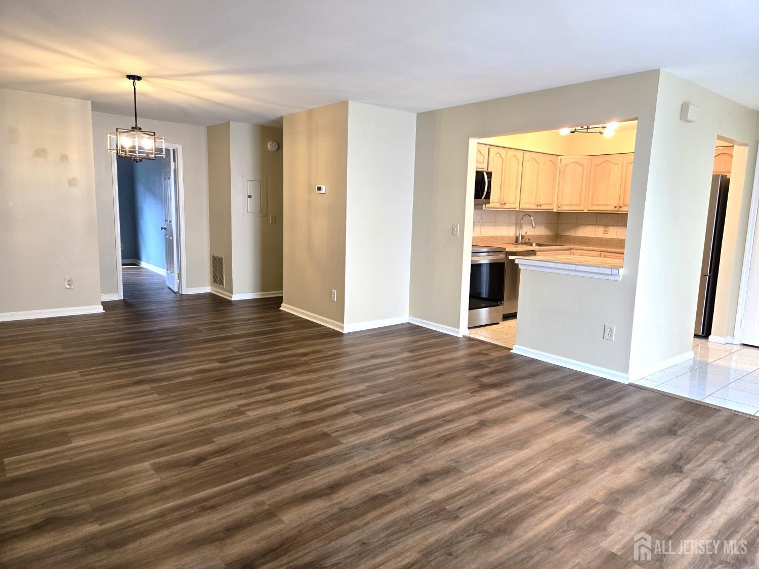 49 Alexandria Way Bernards, NJ 07920 - Photo 6 of 14 an empty room with wooden floor and outdoor view