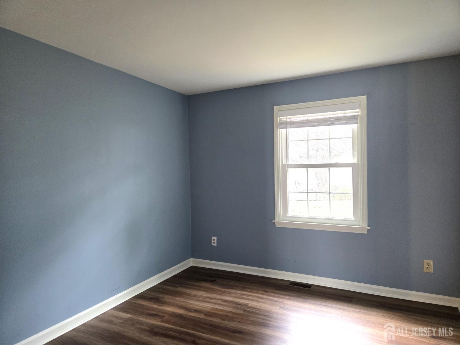49 Alexandria Way Bernards, NJ 07920 - Photo 7 of 14 an empty room with wooden floor and windows