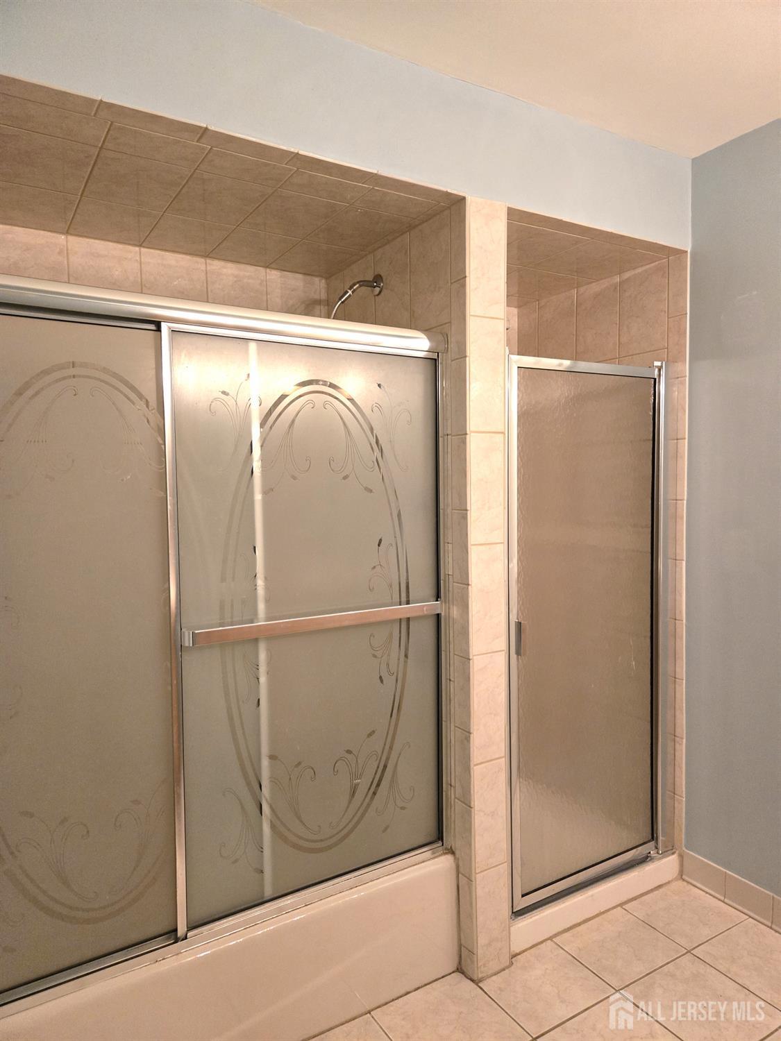 49 Alexandria Way Bernards, NJ 07920 - Photo 9 of 14 a bathroom with a glass shower door