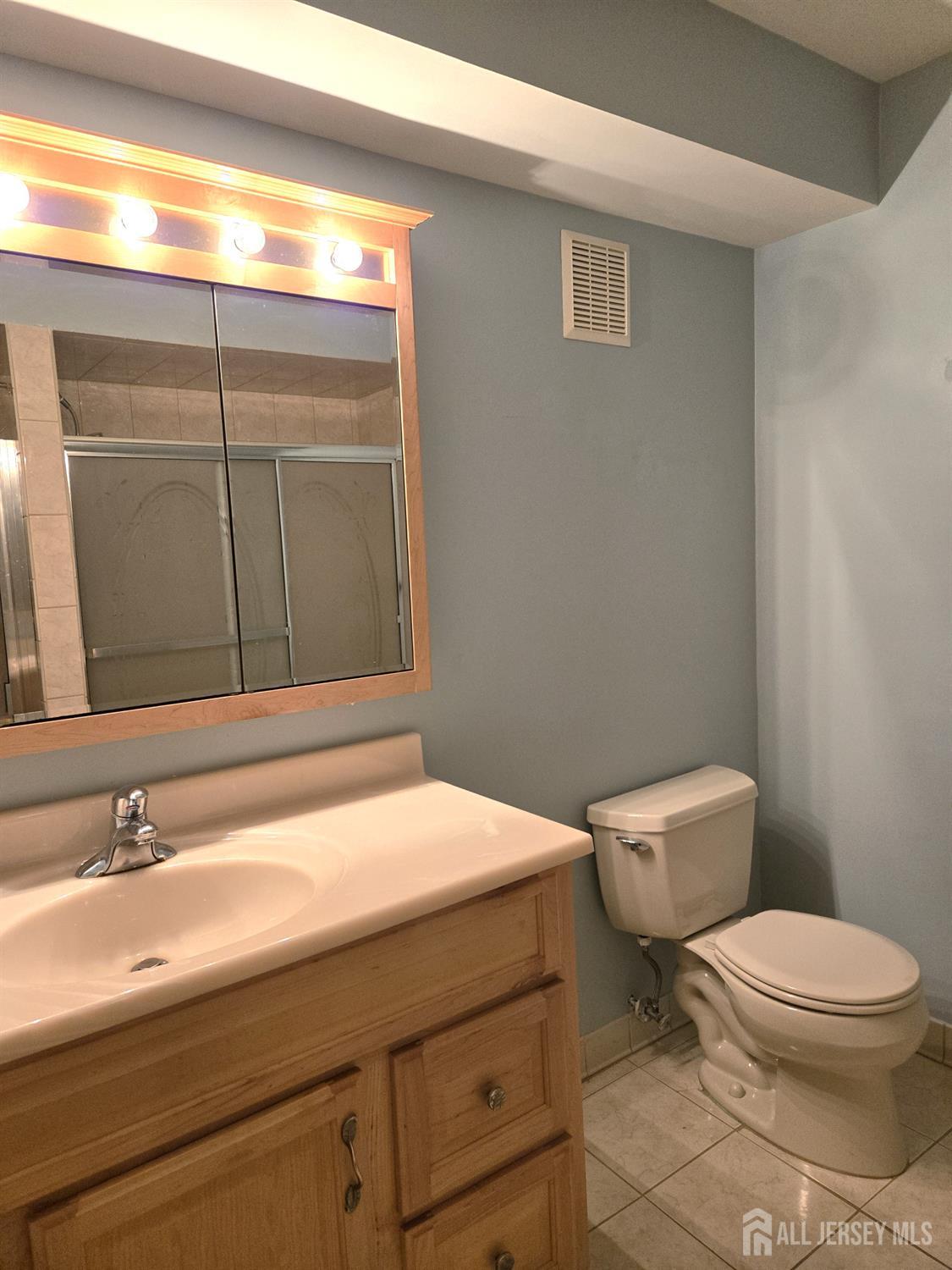 49 Alexandria Way Bernards, NJ 07920 - Photo 10 of 14 a bathroom with a toilet a sink and mirror