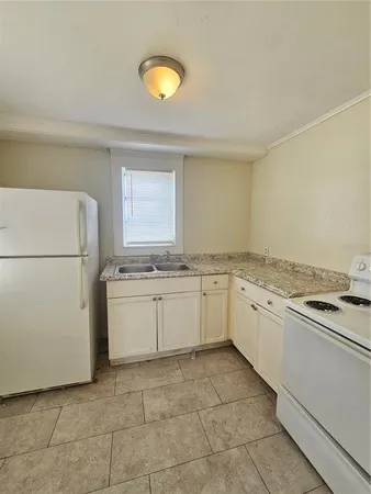 a kitchen with a stove top oven sink and cabinets