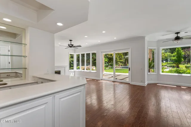 a view of kitchen with granite countertop window and wooden floor