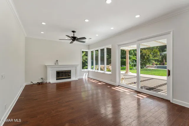 a view of an empty room with a fireplace and a large window