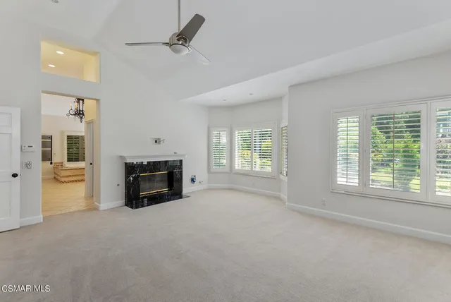 a view of a livingroom with a fireplace and a window