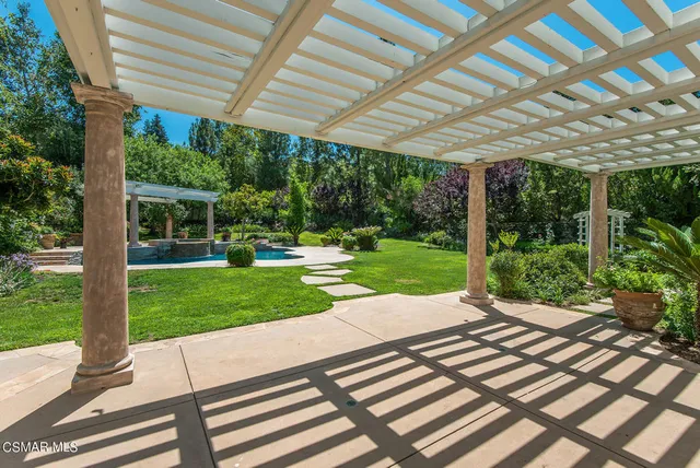 a view of a patio with a table chairs and a backyard