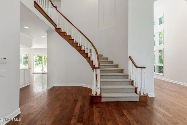 a view of entryway with wooden floor and stairs