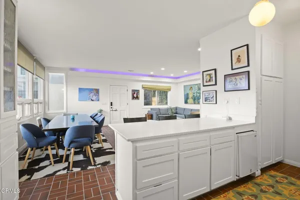 a kitchen with stainless steel appliances granite countertop a sink and a refrigerator