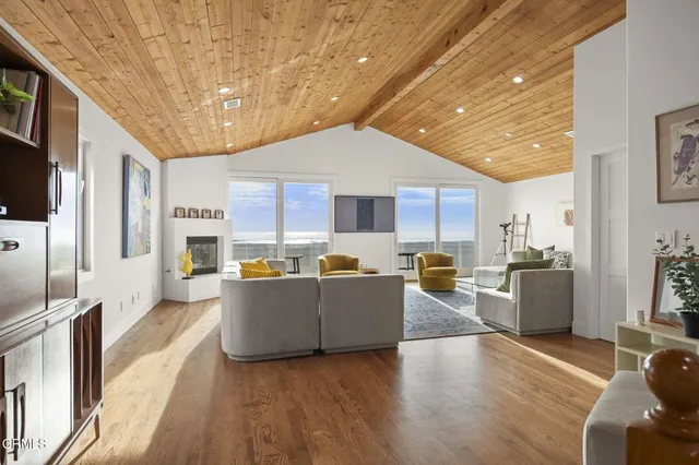 a living room with furniture fireplace and window