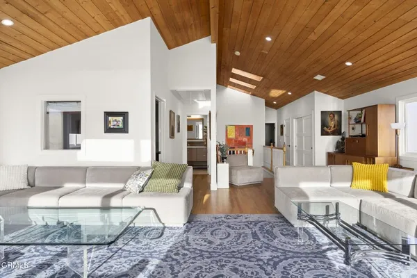 a living room with furniture a rug and a chandelier