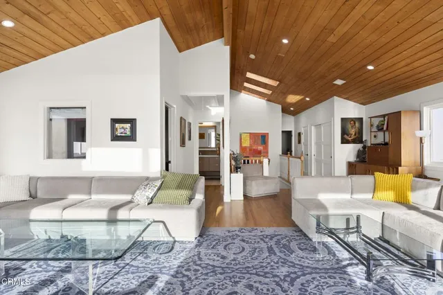 a living room with furniture a rug and a chandelier