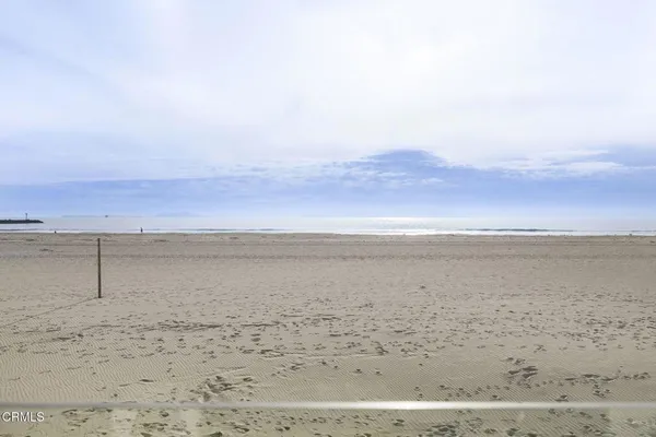 a living room with fireplace furniture and floor to ceiling window