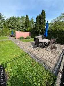 an outdoor space with furniture and garden