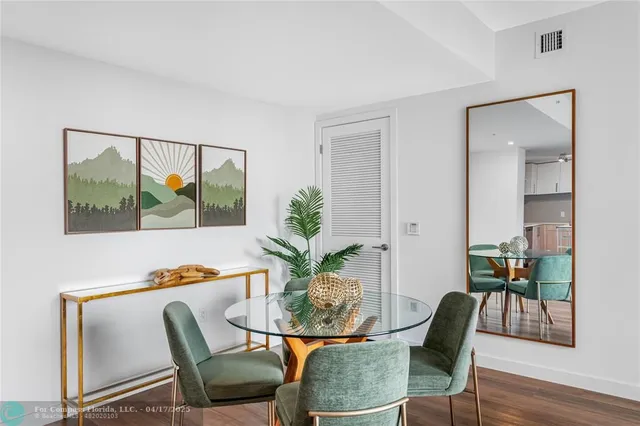 a view of a dining room with furniture window and wooden floor