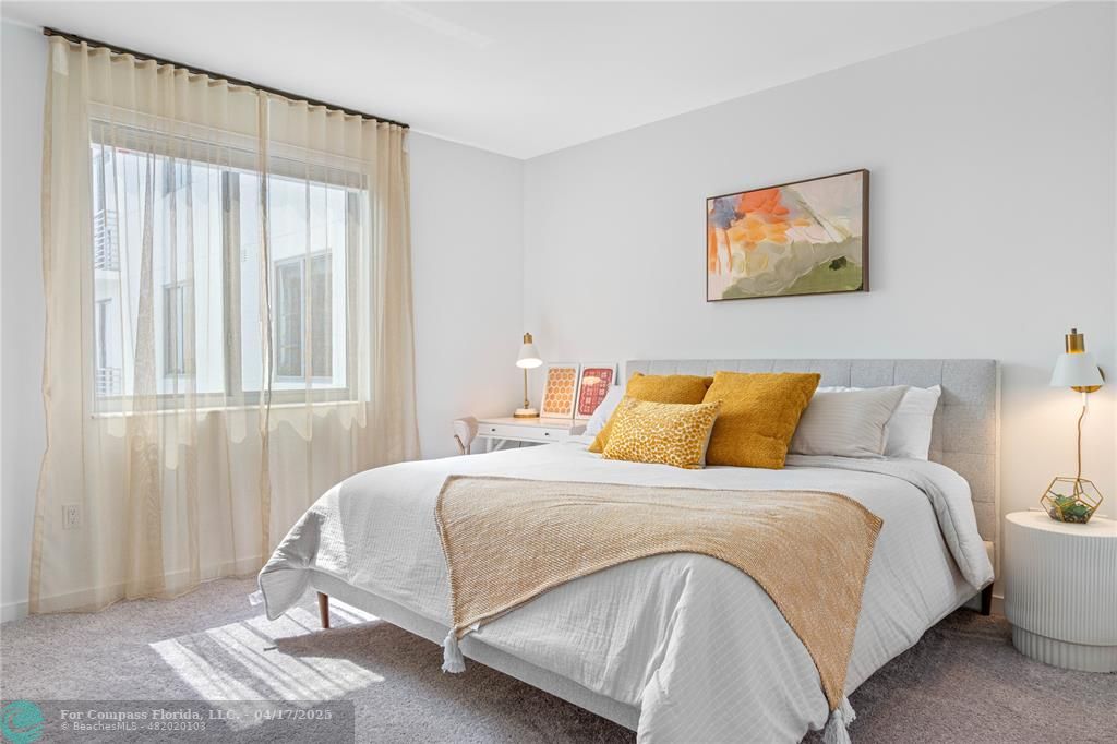 200 Northeast 1st Avenue, Unit 1027 Pompano Beach, FL 33060 - Photo 2 of 18 a bedroom with a bed and a window