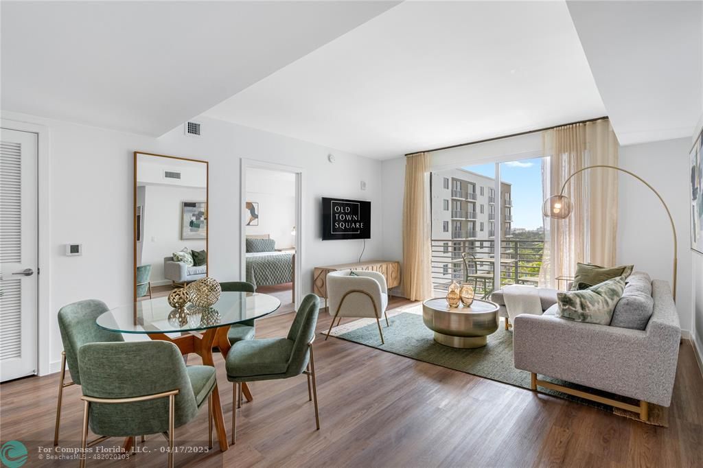 200 Northeast 1st Avenue, Unit 1027 Pompano Beach, FL 33060 - Photo 4 of 18 a living room with furniture and a window