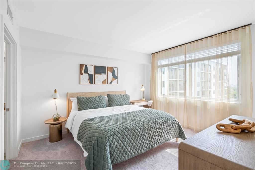 200 Northeast 1st Avenue, Unit 1027 Pompano Beach, FL 33060 - Photo 6 of 18 a bedroom with a bed and a window