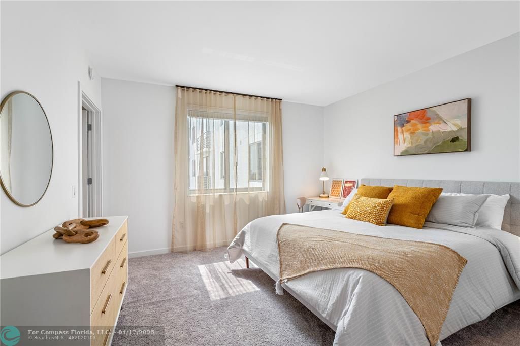 200 Northeast 1st Avenue, Unit 1027 Pompano Beach, FL 33060 - Photo 8 of 18 a bedroom with a bed and a window