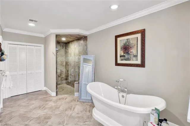 a room with stainless steel appliances kitchen island granite countertop a sink and chairs