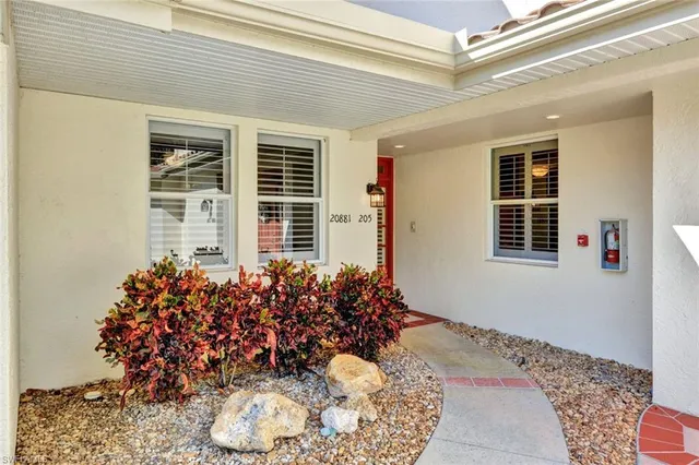 a vase of flowers sitting on a floor
