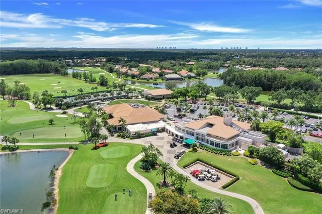 a room with lots of tables a large window and chairs