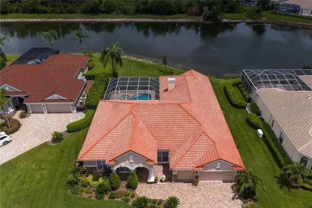 an aerial view of a house with a lake view