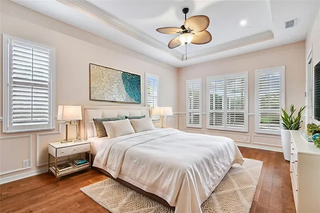 a living room with furniture a flat screen tv and a large window