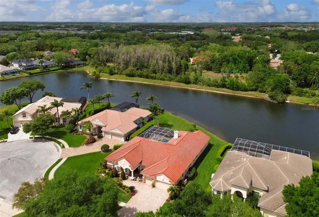an aerial view of a house with a lake view
