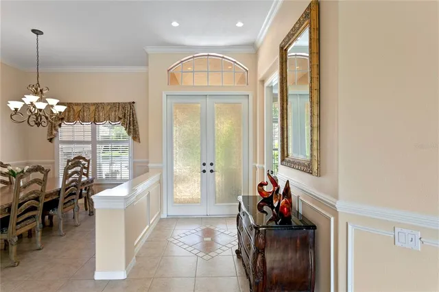 a view of a dining room with furniture and chandelier