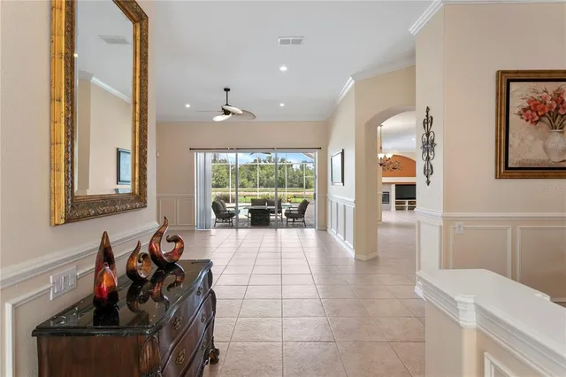 a kitchen with stainless steel appliances granite countertop a stove top oven a refrigerator a sink and dishwasher with white cabinets