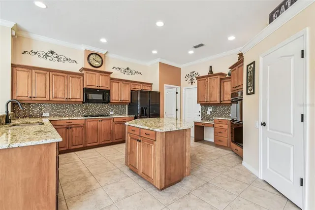 a spacious bedroom with a large bed and a chandelier
