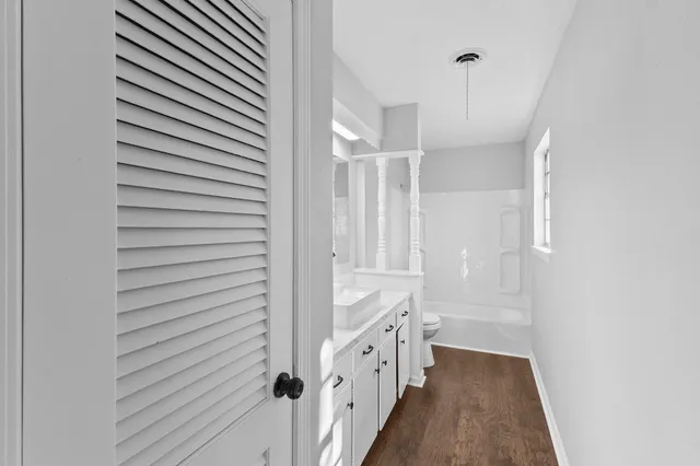a view of a hallway with wooden floor