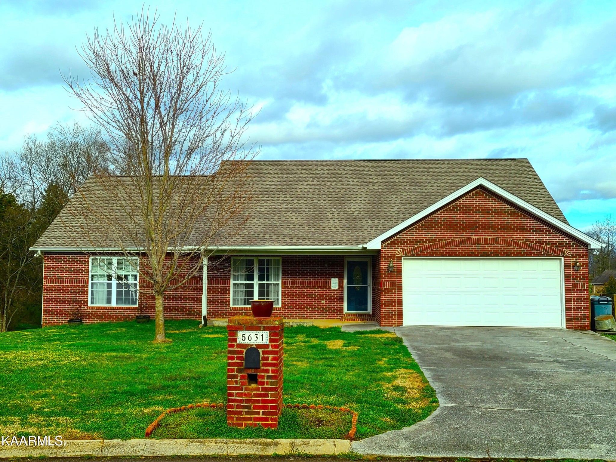 5631 J. Riley W Drive Greenback, TN 37742 - Photo 1 of 28 a front view of a house with a yard and garage