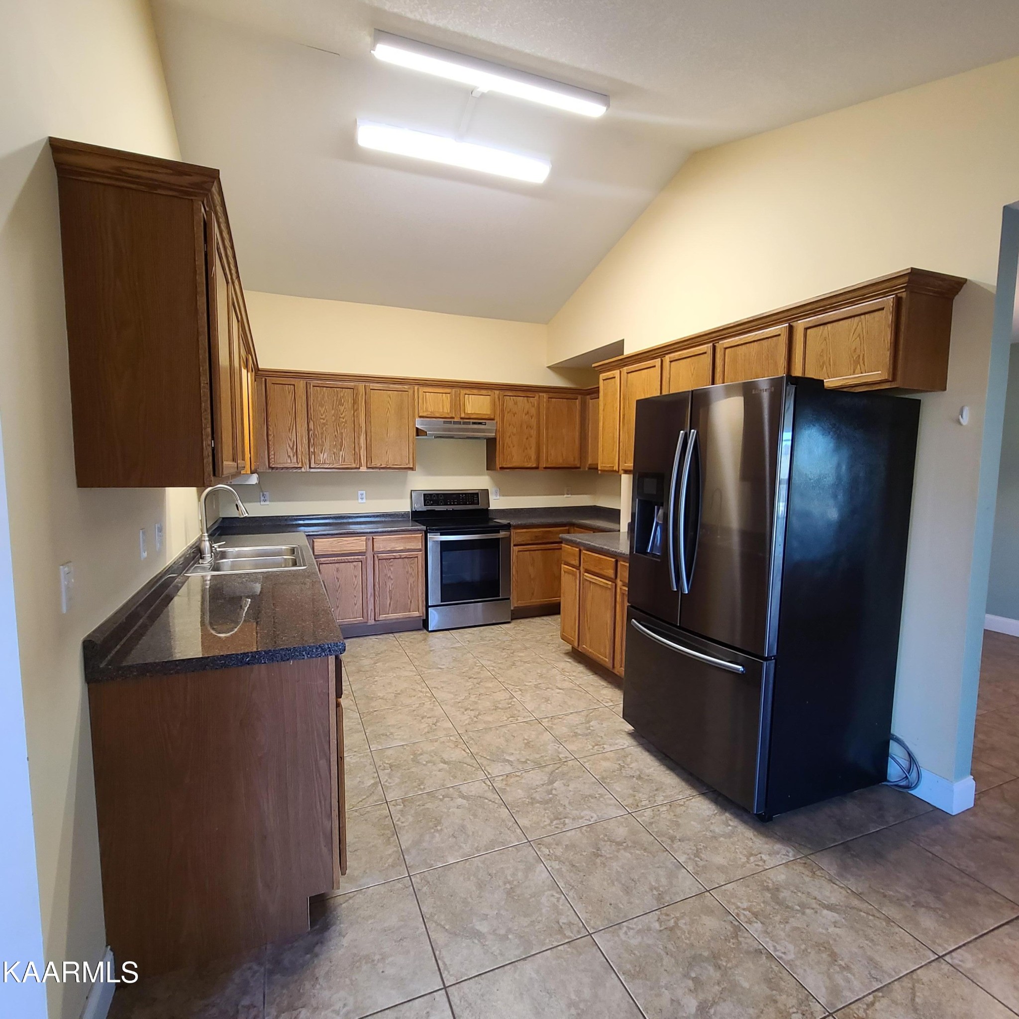 5631 J. Riley W Drive Greenback, TN 37742 - Photo 7 of 28 a kitchen with stainless steel appliances granite countertop a refrigerator and a stove
