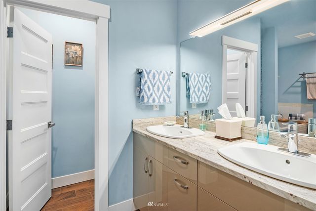 a bathroom with a double vanity sink mirror and double